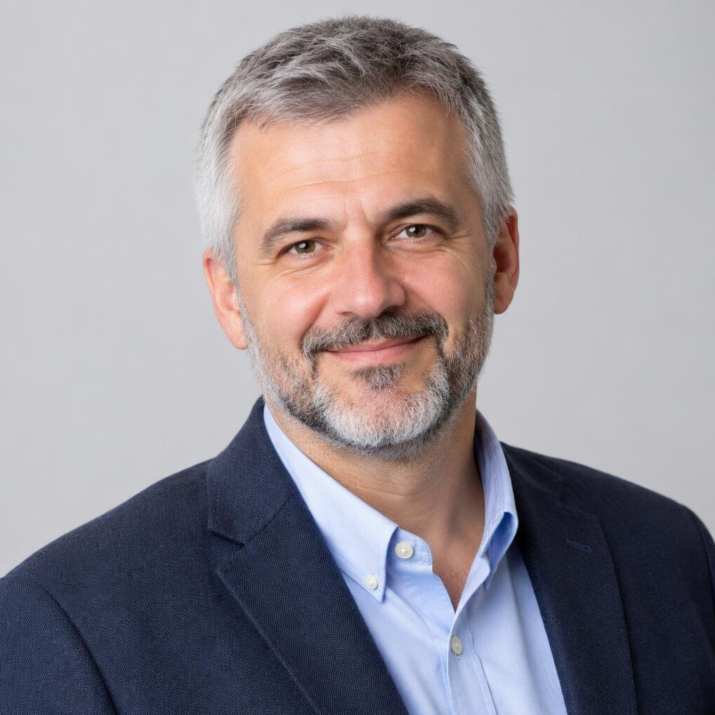 Portrait of a man with gray hair and a beard